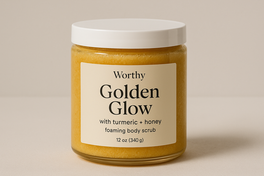 create a creamy deep yellow colored sugar body scrub in a 12oz jar with a white top. The label should say "Golden Glow" and underneath in smaller size letters it should say "with turmeric + honey". Below that add foaming body scrub. also add the name "Worthy" to the top of the label