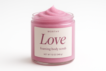 create a creamy pastel fuschia colored sugar body scrub in a 12oz jar with a white top. The label should say "Love" and underneath in smaller size letters it should say "foaming body scrub" also add the name "Worthy" to the top of the label