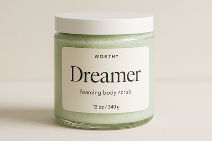 create a creamy pastel green colored sugar body scrub in a 12oz jar with a white top. The label should say "Dreamer" and underneath in smaller size letters it should say "foaming body scrub" also add the name "Worthy" to the top of the label