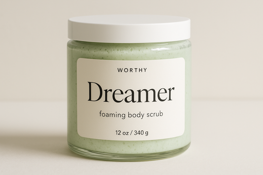 create a creamy pastel green colored sugar body scrub in a 12oz jar with a white top. The label should say "Dreamer" and underneath in smaller size letters it should say "foaming body scrub" also add the name "Worthy" to the top of the label